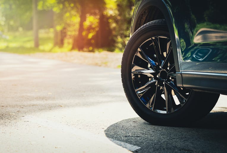 sport car with black alloy wheels on asphalt road. copy space