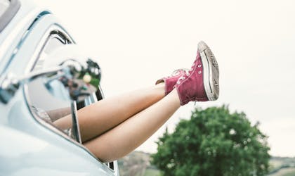 Woman legs outside a vintage car. concept about carefree and freedom